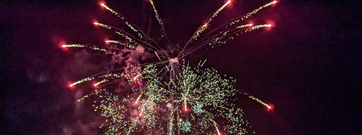 fireworks by a pier at night