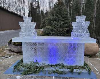 a sculpted ice bar lit up in blue