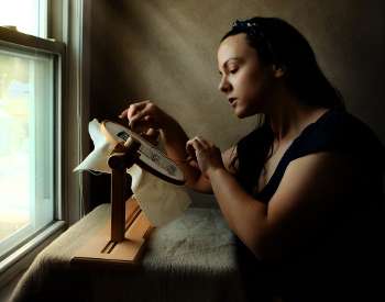 "Girl at Window with Embroidery," photograph by Rachael Kmack
