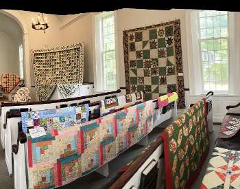 Handmade Quilts hanging in a room