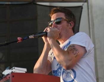 Chris Carey singing into microphone