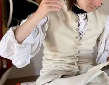 close up of soldier sewing