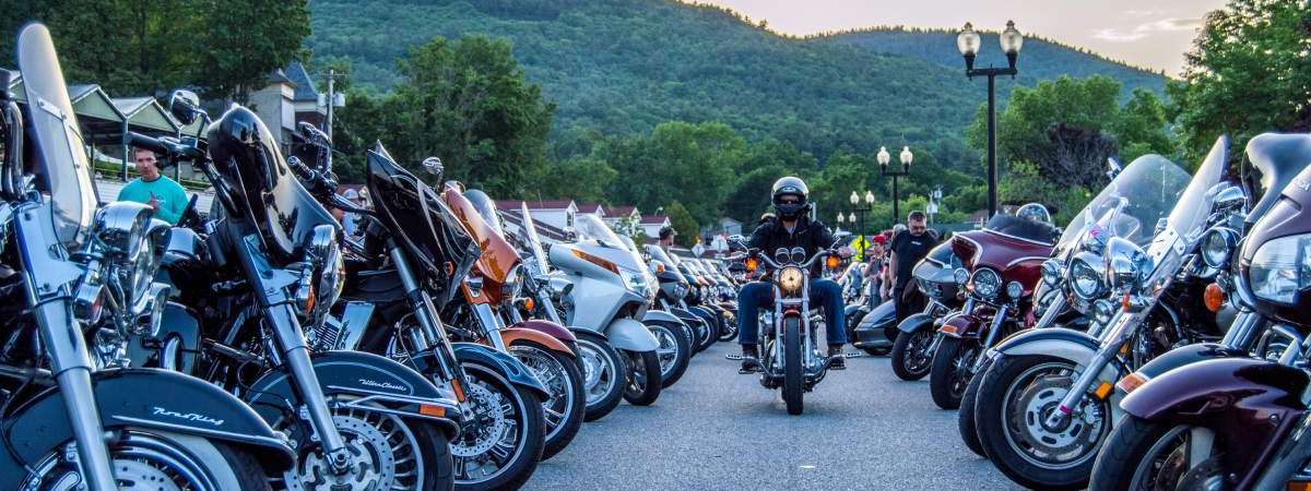 man riding motorcycle through lane of motorcycles