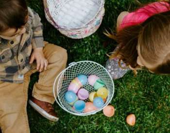 kids sitting with easter eggs