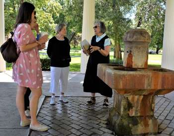 people standing by a mineral spring