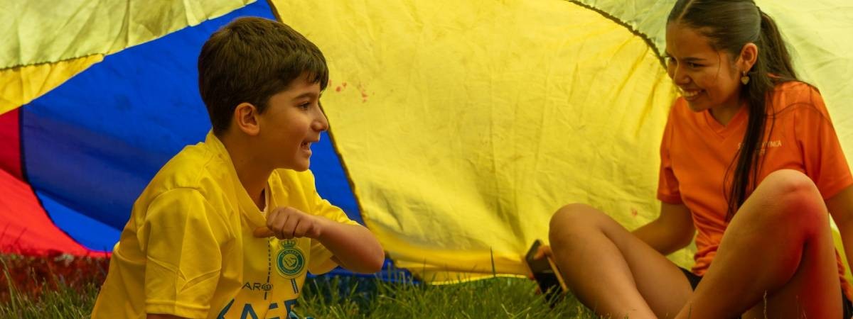 kids under colorful tent