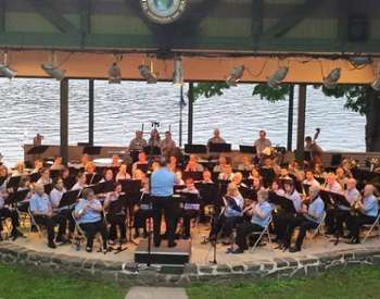 band plays in park by water