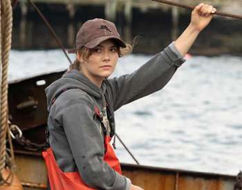 woman in hat on fishing boat