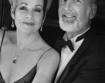 black and white photo of elegantly dressed woman and man