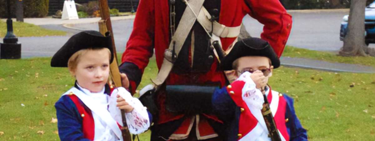 man posing with kids dresses like him