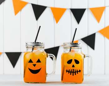 halloween themed mason jars with orange and black banner background