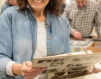 woman holding up vinyls