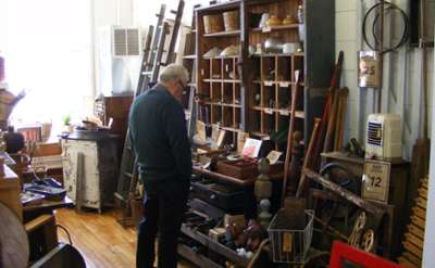 man looks at antiques for sale