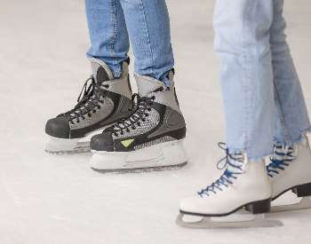 closeup of ice skates on ice