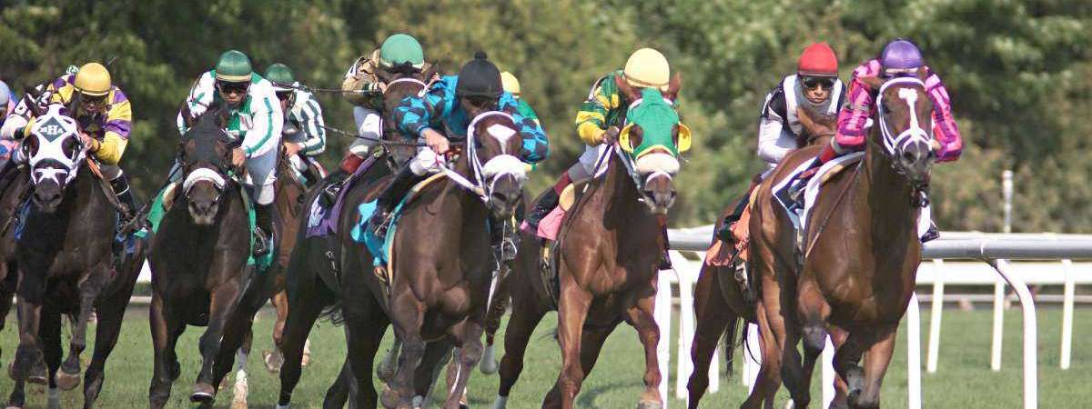 horses racing with jockeys