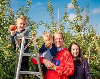 family at an apple orchard