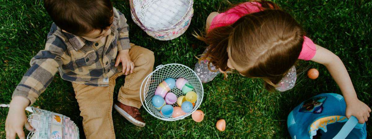 kids with easter eggs on a lawn