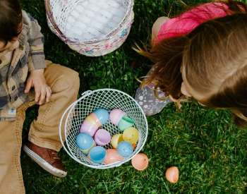 kids with easter eggs on a lawn