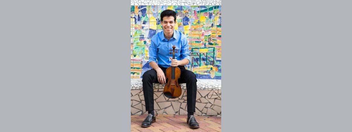 man poses with violin