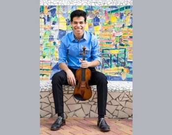 man poses with violin