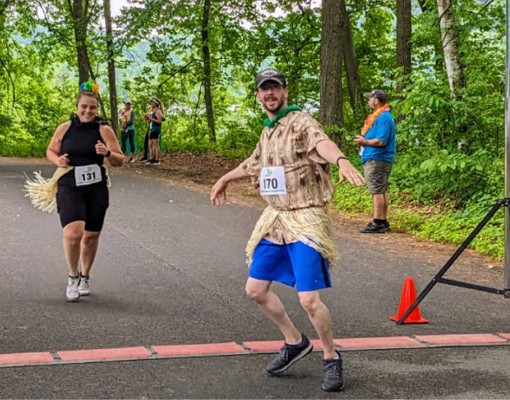 man hulas across finish line