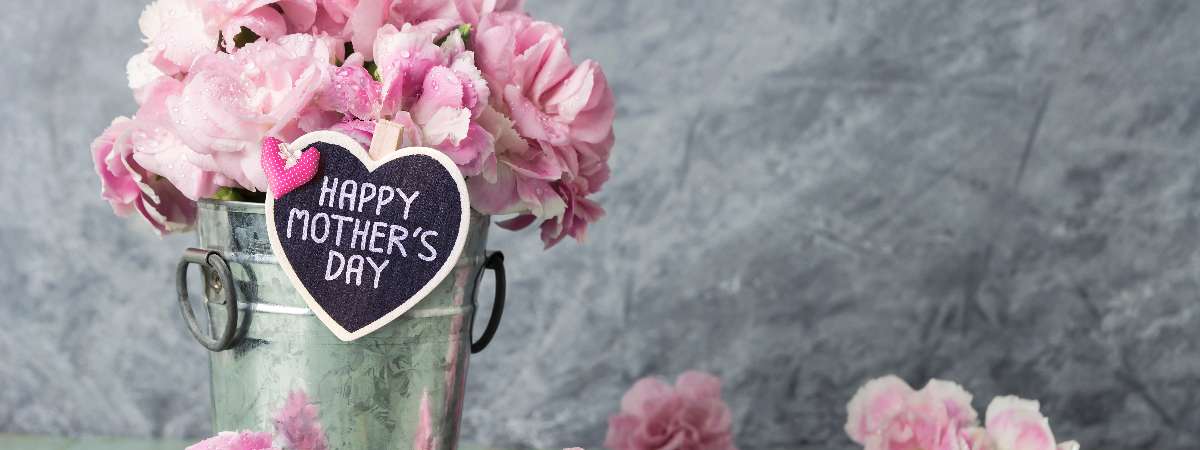 mother's day sign with pink flowers in pail