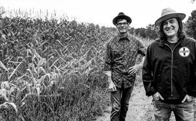 three musicians by cornfield 