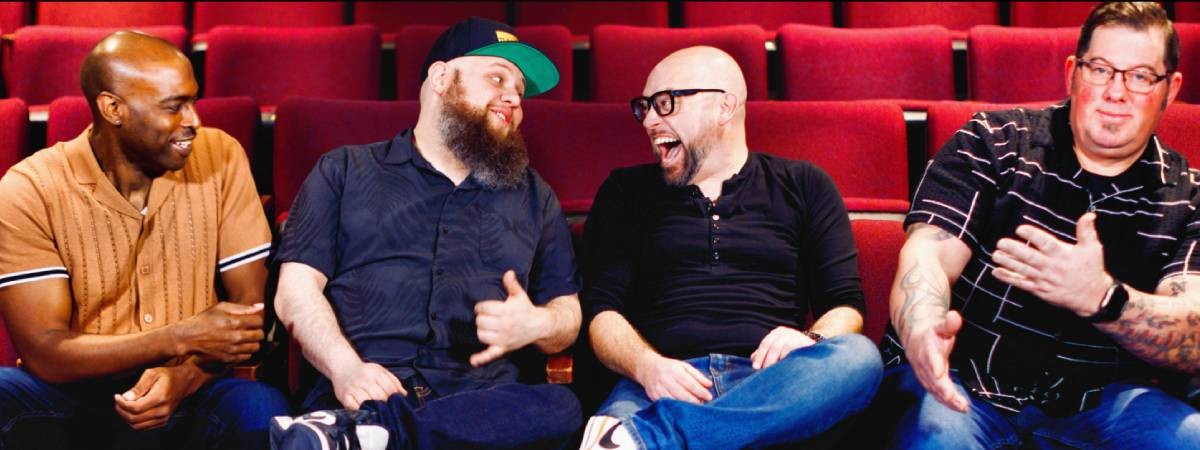 four men in a theater