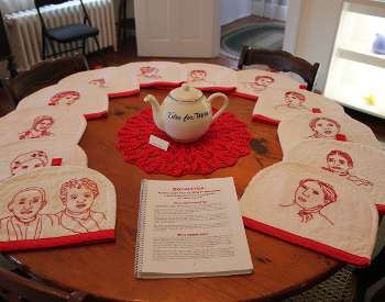 Tea cozies with suffragette images