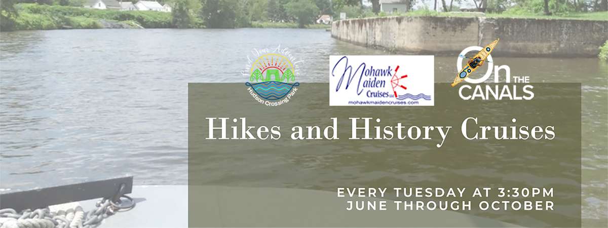 The view from the Mohawk Maiden Cruise boat as it's going down the Champlain Canal. Logos for Hudson Crossing Park, Mohawk Maiden Cruises, and On the Canals are on the photo.