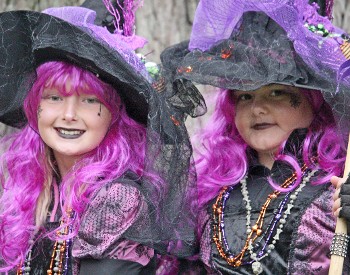 two young women dressed as witches with purple hair