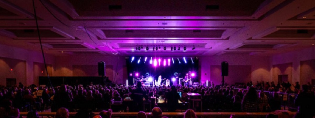 indoor performance with fans watching musicians on stage