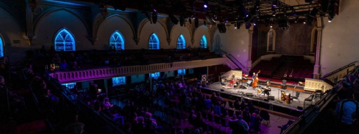 indoor concert with crowd watching musicians on stage