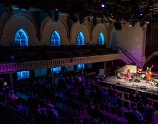 indoor concert with crowd watching musicians on stage