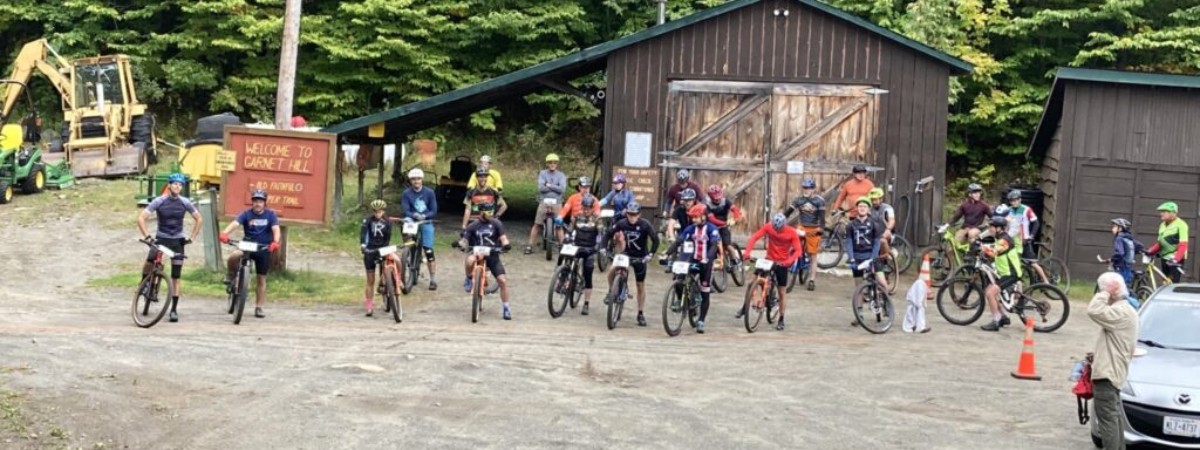 group of people on bikes on a gravel road