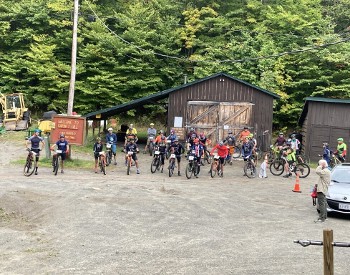 group of people on bikes on a gravel road