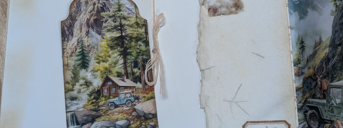 Inside a paper journal with a cabin and jeep in the image