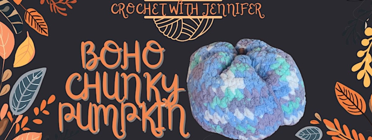 Crocheted pumpkin shape in tones of blue with a drawing of a ball of yarn with knitting needles