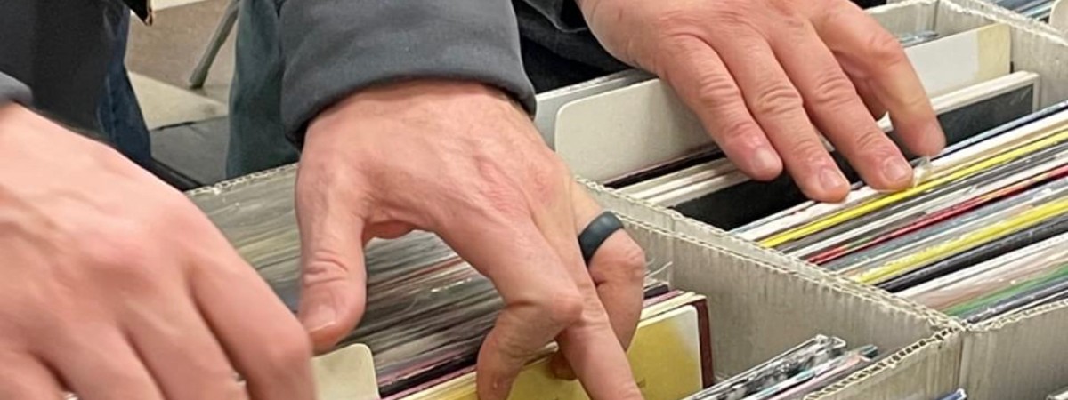 hands browsing through records