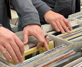 hands browsing through records