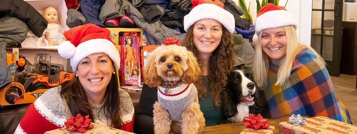 christmasy people pose with dog