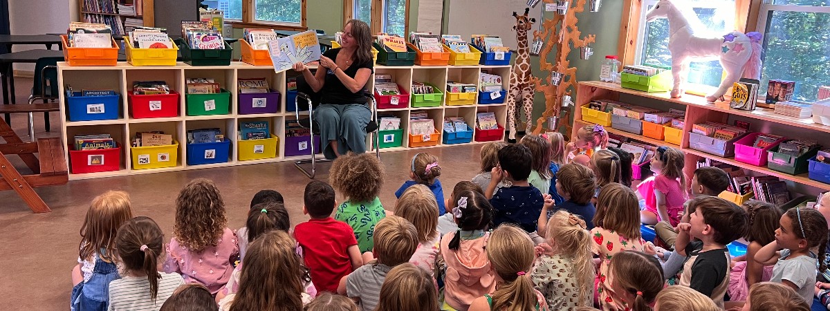 Lower school students enjoy story time on one of the 3 libraries at Saratoga Independent School