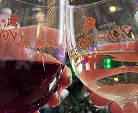 adirondack winery wine glasses cheersing in front of christmas tree