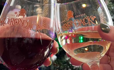 adirondack winery wine glasses cheersing in front of christmas tree