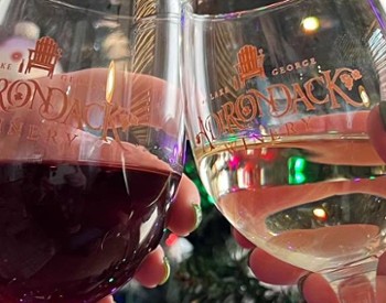 adirondack winery wine glasses cheersing in front of christmas tree