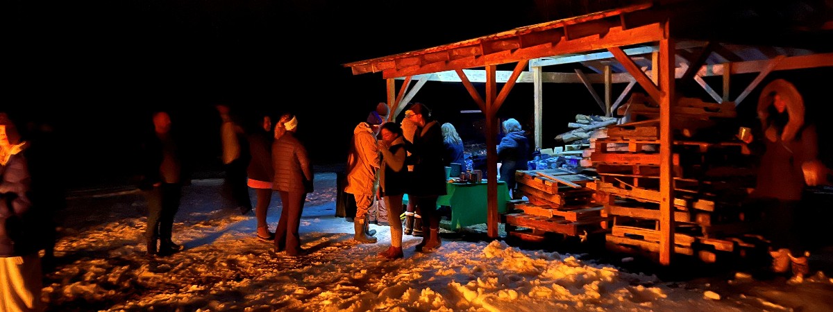 Fireside by bar tucked back into the woods at our ski park. Snowshoe, ski or walk back the trek to enjoy this outdoor party.