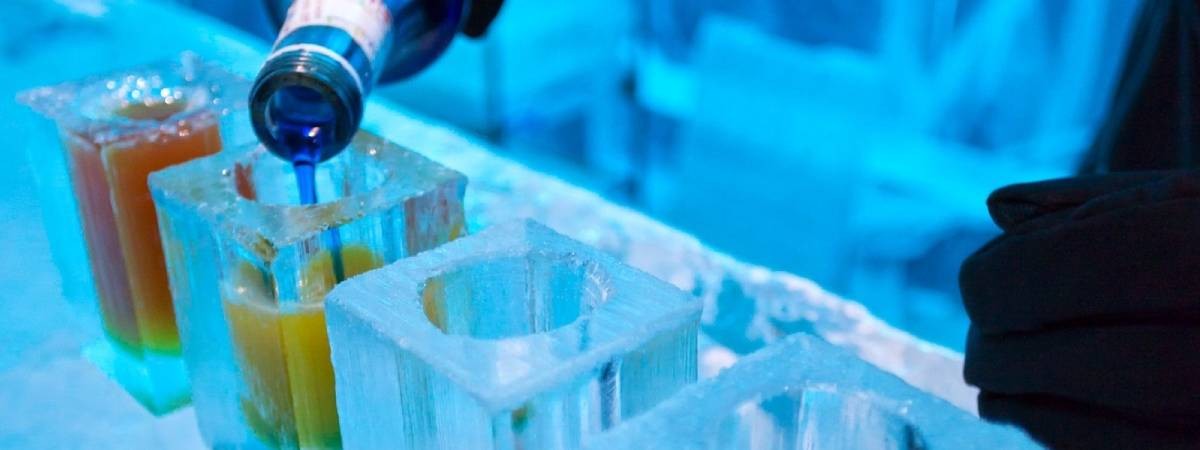 drink being pourced in ice at ice bar