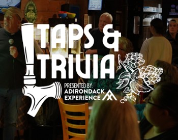 Taps & Trivia logo with Full crowd at the Garrison in the background