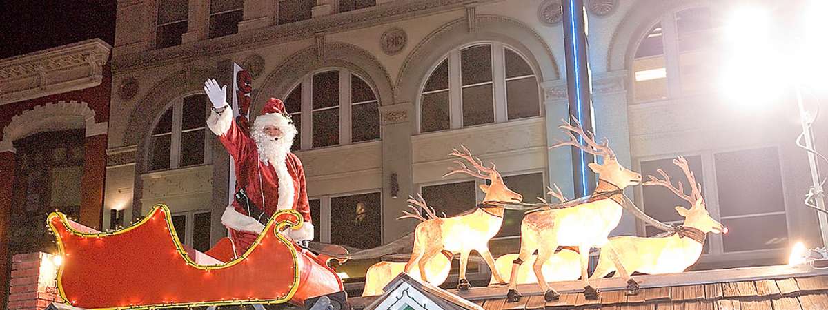 Santa and reindeer on roof in parade