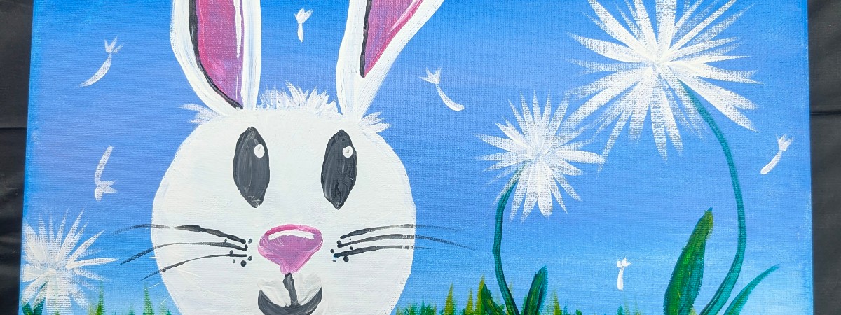 Painted white bunny with dandelions and grass